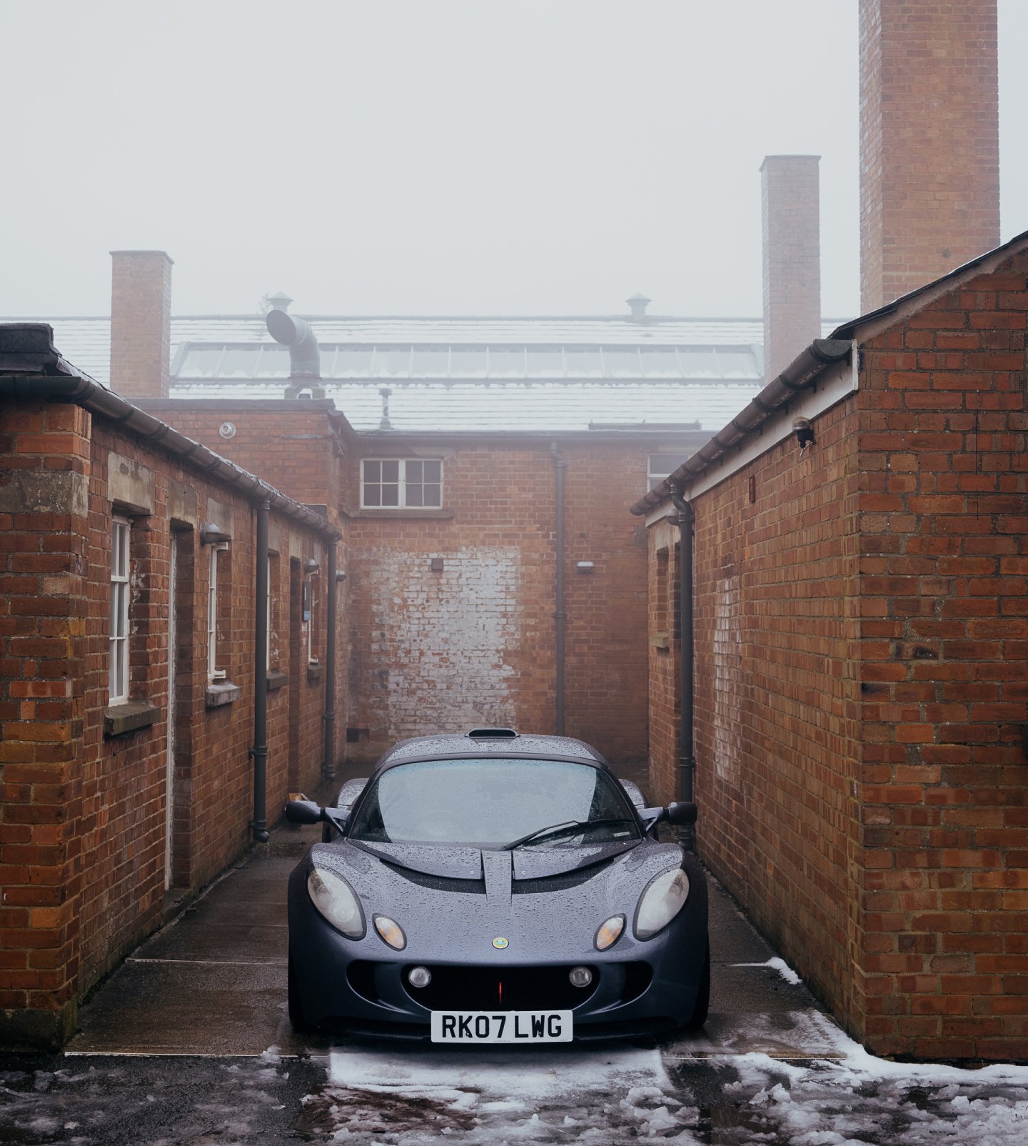 A close up of the front of a classic Yellow BMW, showing the badge in detail